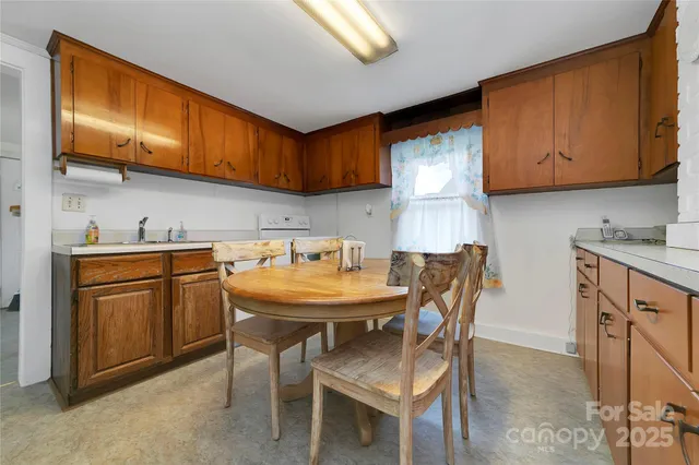 a kitchen with stainless steel appliances wooden cabinets a center island and a refrigerator