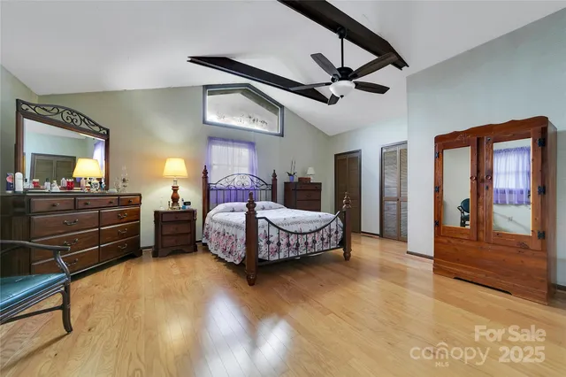 a bedroom with a bed and dresser with mirror