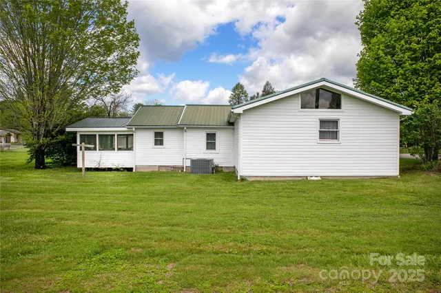 a view of a house with a yard and sitting area
