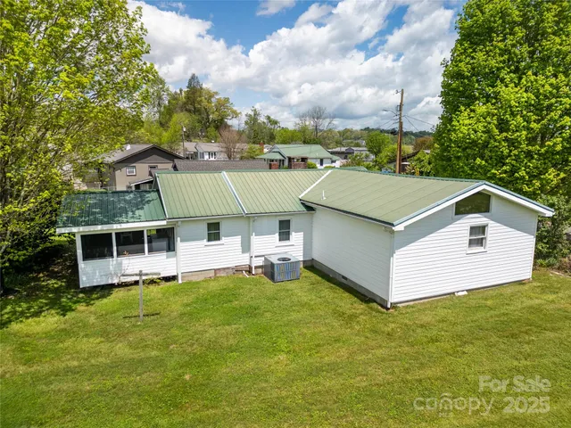 an aerial view of a house with a swimming pool yard and outdoor seating