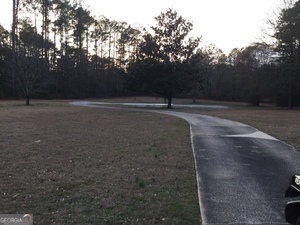 550 Ginger Cake Road Fayetteville, GA 30214 - Photo 7 of 9 a view of dirt field with trees in the background