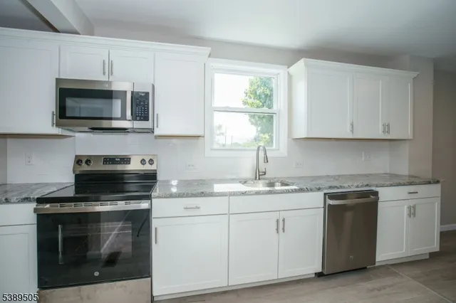 a kitchen with a sink cabinets and window