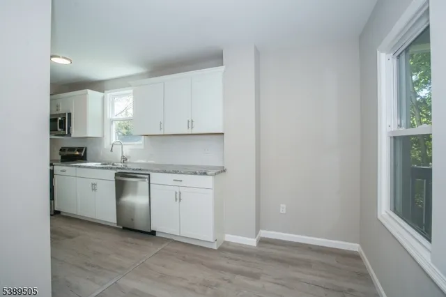 an empty room with wooden floor and closet
