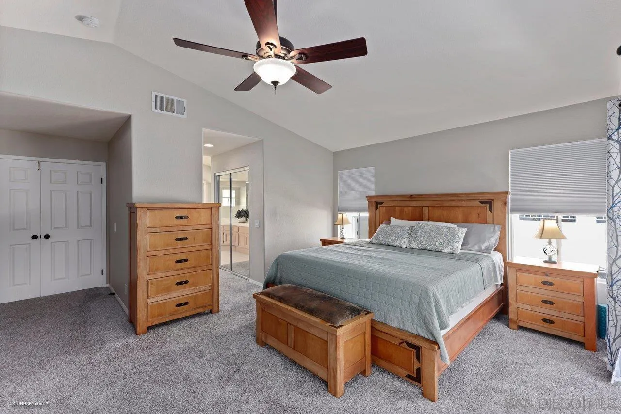 3707 Via Del Rancho Oceanside, CA 92056 - Photo 25 of 45 a bedroom with a bed and a chandelier
