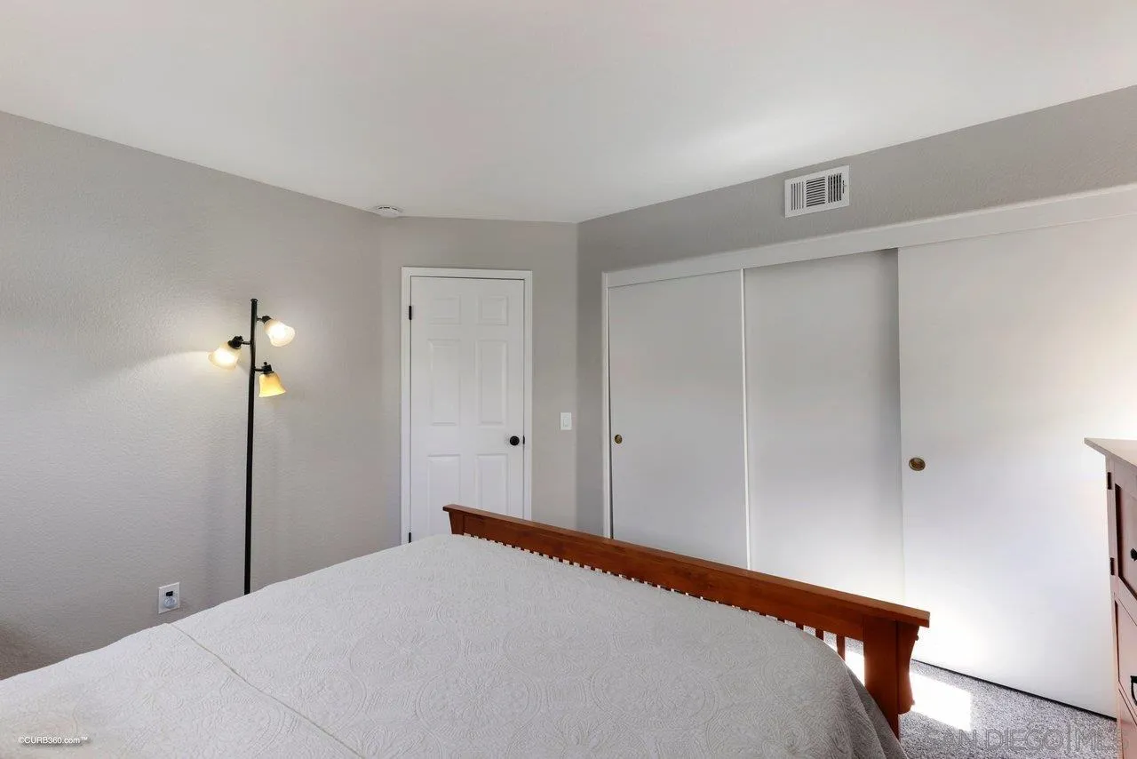 3707 Via Del Rancho Oceanside, CA 92056 - Photo 35 of 45 a bedroom with a bed and a lamp
