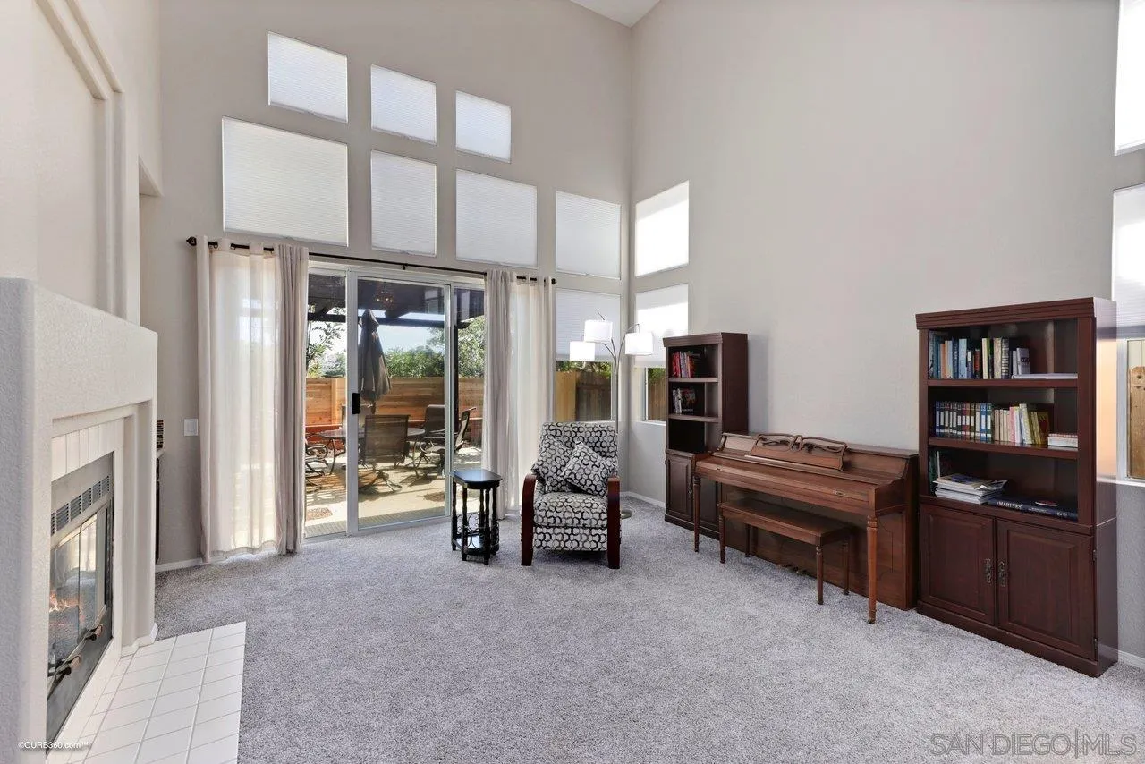3707 Via Del Rancho Oceanside, CA 92056 - Photo 8 of 45 a living room with furniture a fireplace and a flat screen tv