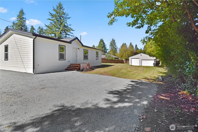 a view of a house with a backyard