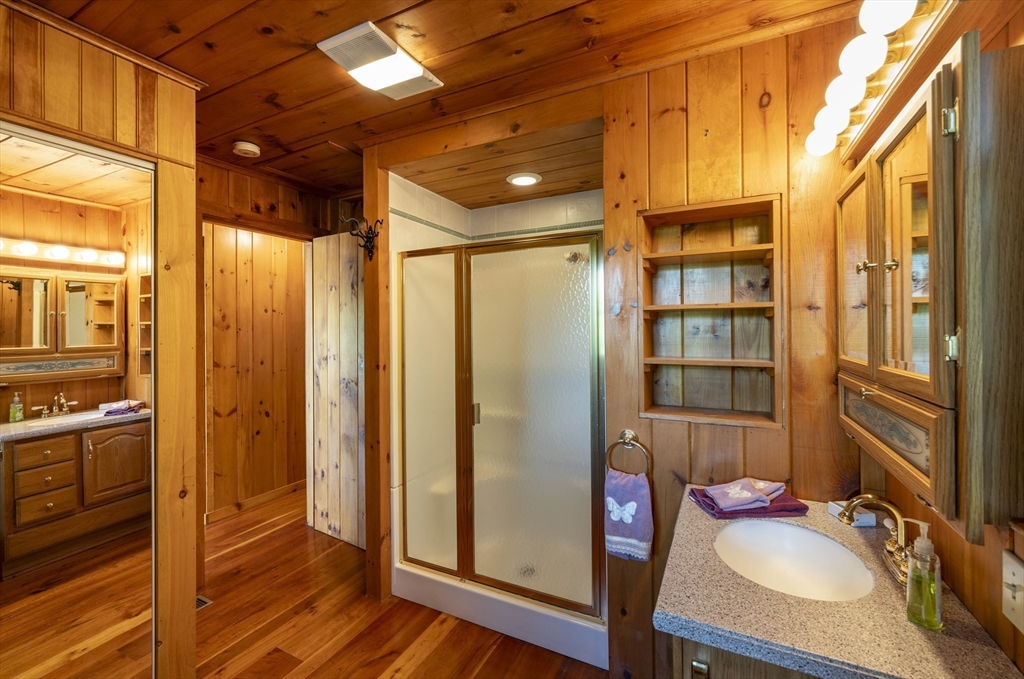 27 Pond Hill Road Goshen, MA 01096 - Photo 16 of 40 a bathroom with double vanity and a shower