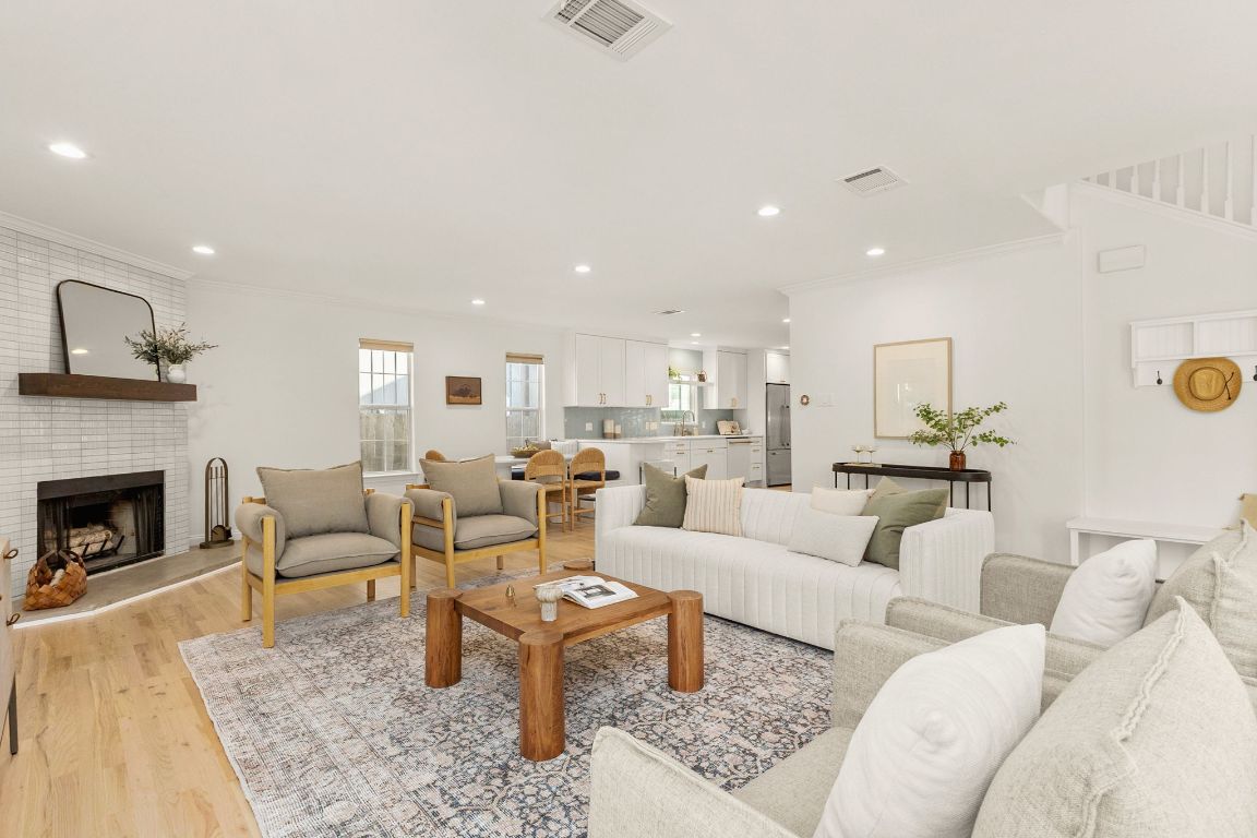 4312 Rosedale Avenue Austin, TX 78756 - Photo 18 of 40 Living area with light wood-style flooring, a brick fireplace, crown molding, and recessed lighting