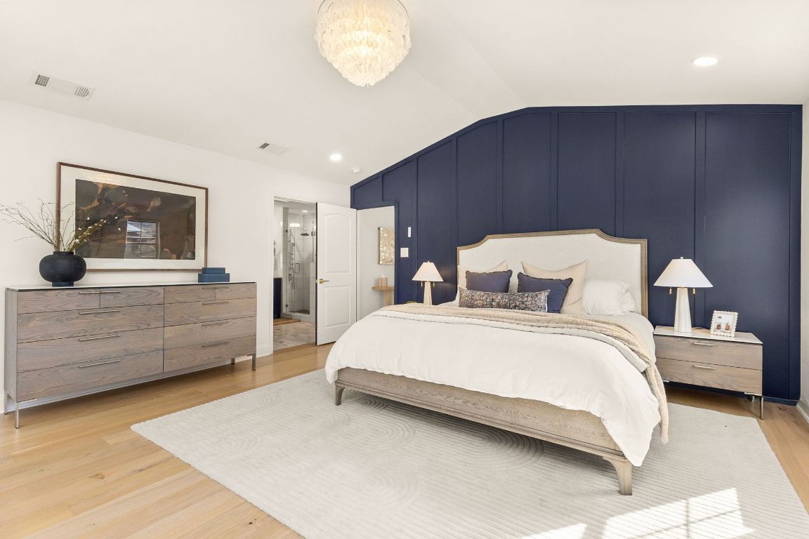 4312 Rosedale Avenue Austin, TX 78756 - Photo 24 of 40 En-suite primary bedroom featuring vaulted ceiling, light wood finished floors, and recessed lighting