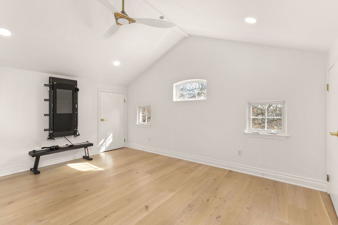 4312 Rosedale Avenue Austin, TX 78756 - Photo 34 of 40 Media room or bedroom with vaulted ceiling, hardwoods, ceiling fan, recessed lighting and two closets
