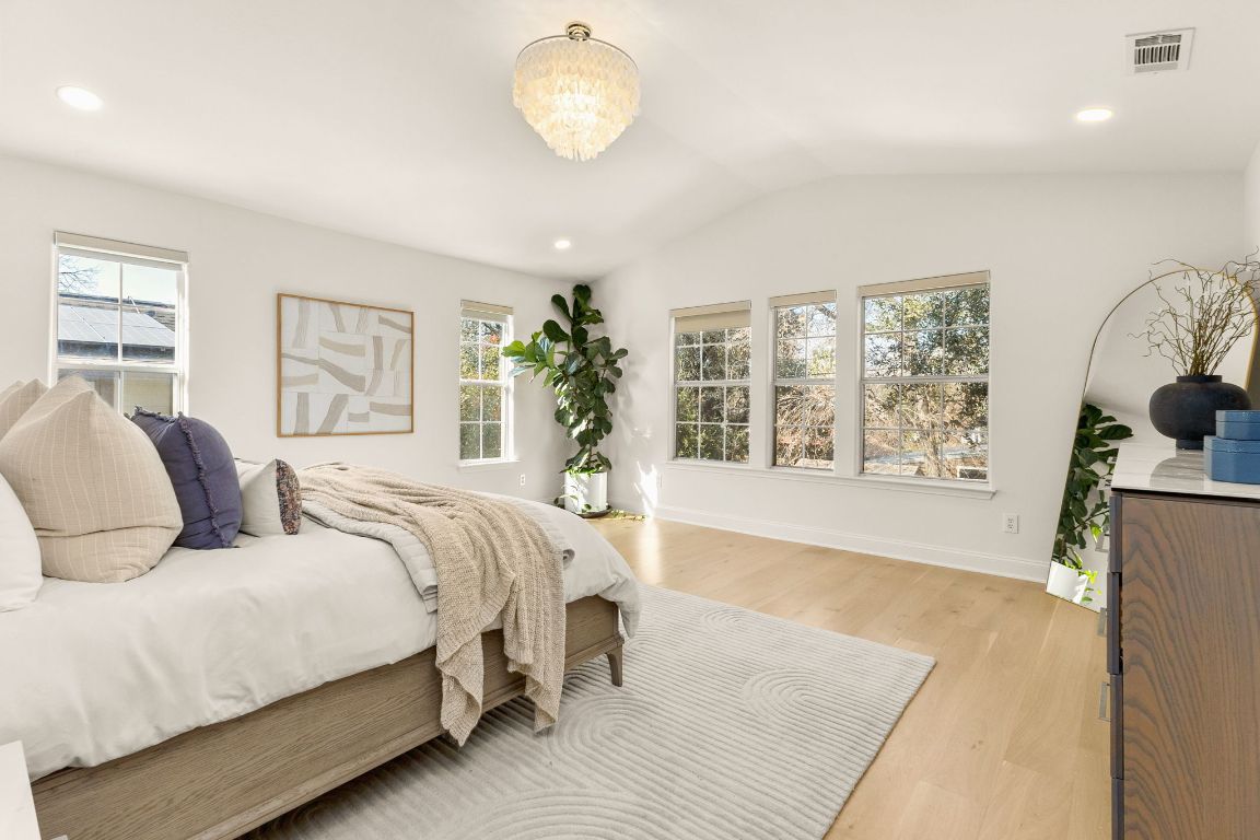 4312 Rosedale Avenue Austin, TX 78756 - Photo 7 of 40 En-suite primary bedroom with lofted ceiling, light wood-style floors, and recessed lighting