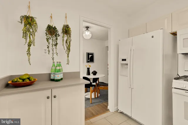 a kitchen with a refrigerator and a table