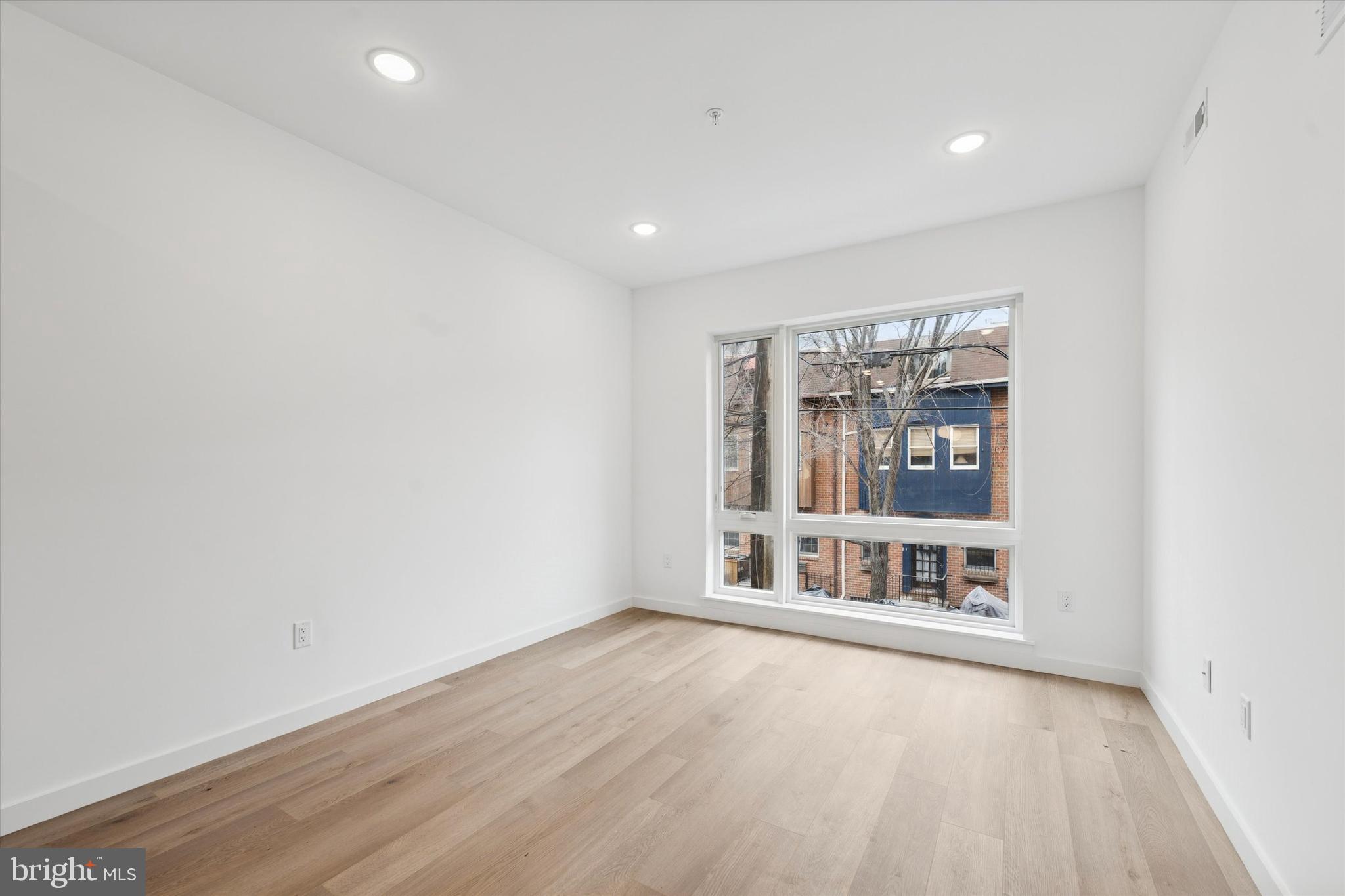 754 South 4th Street, Unit 405 Philadelphia, PA 19147 - Photo 5 of 18 wooden floor in an empty room with a window