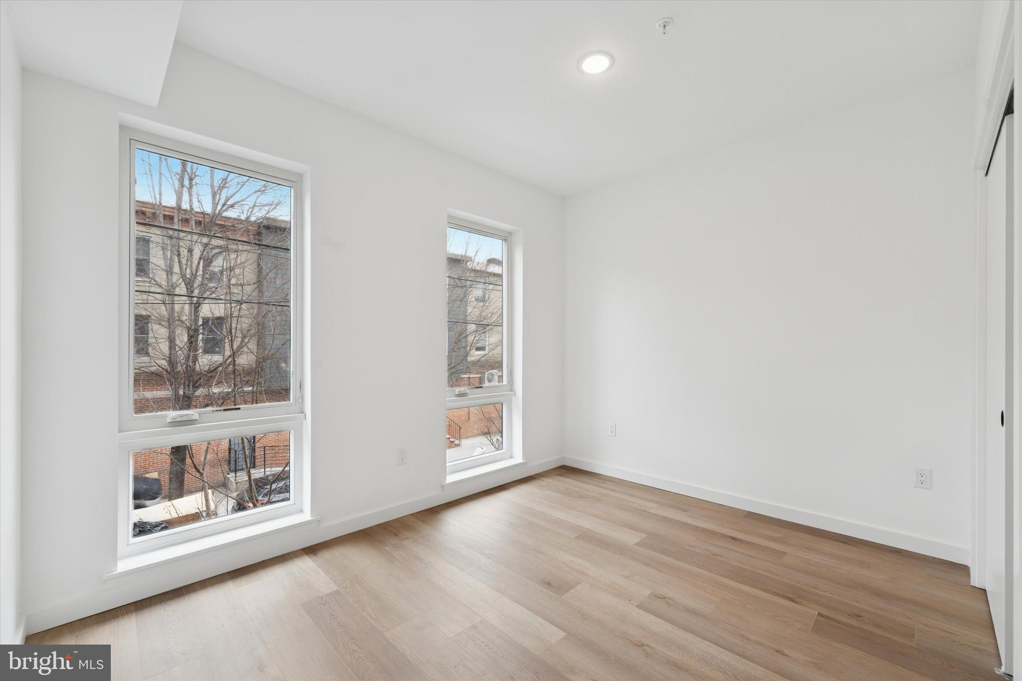 754 South 4th Street, Unit 405 Philadelphia, PA 19147 - Photo 9 of 18 an empty room with wooden floor and windows