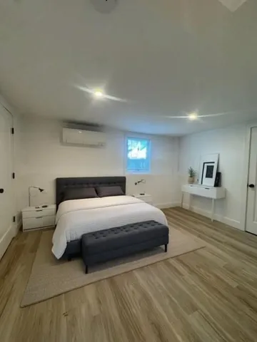 a bedroom with a bed and a view of kitchen