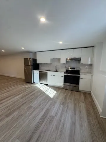 a room with a couch and a stove top oven