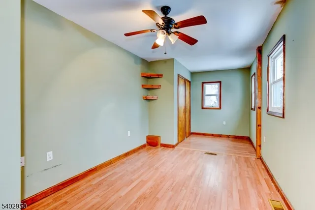 a view of a room with a ceiling fan
