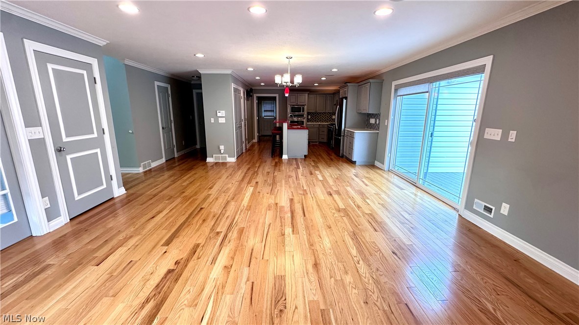 2603 Rockefeller Road Wickliffe, OH 44092 - Photo 4 of 34 Expansive open-concept living area featuring hardwood flooring, recessed lighting, and a sliding glass door