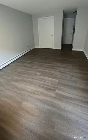 an empty room with wooden floor