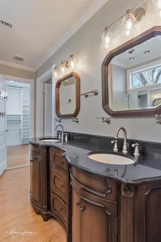 a bathroom with a double vanity sink and a mirror