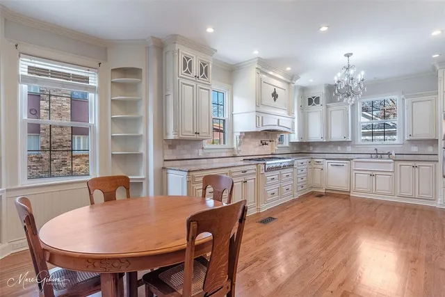 a large kitchen with cabinets table and chairs