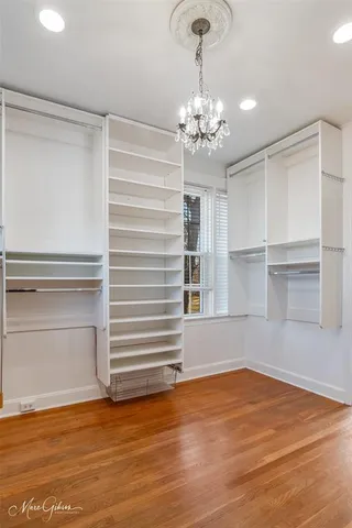 a view of a room with wooden floor and window