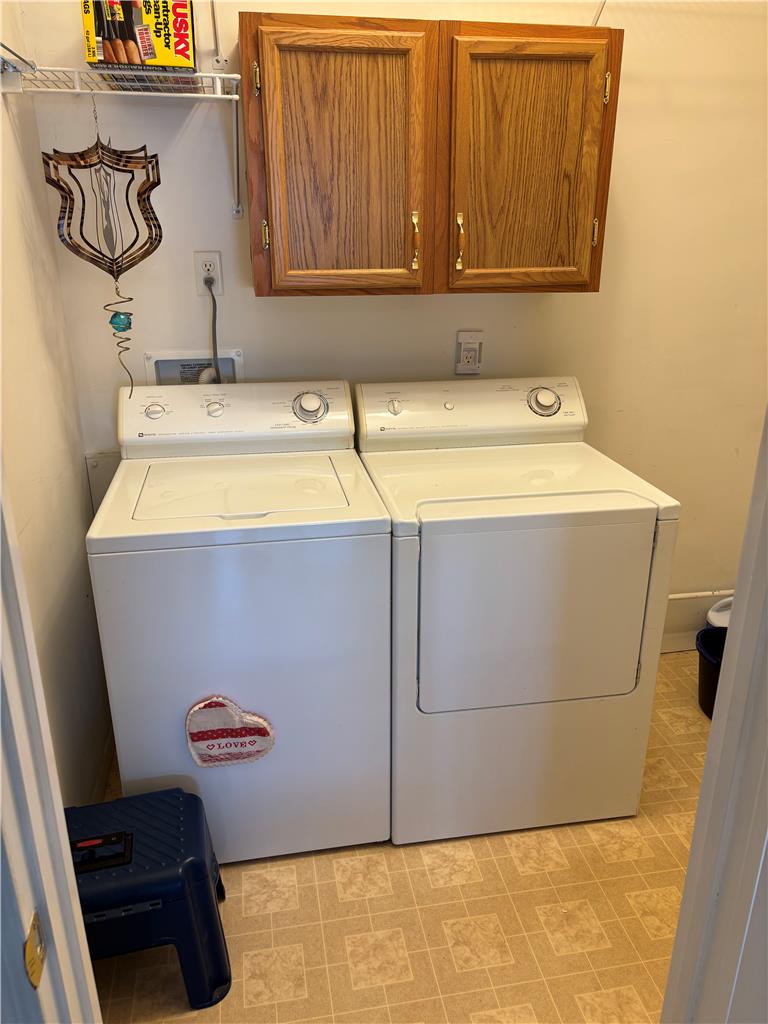 11 Abbey Road Easton, PA 18040 - Photo 24 of 24 Functional laundry setup includes built-in cabinetry and durable tiled flooring.