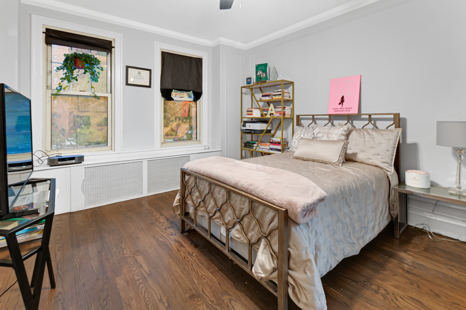5000 South East End Avenue, Unit 2D Chicago, IL 60615 - Photo 14 of 22 a bedroom with a bed a bookshelf and a window
