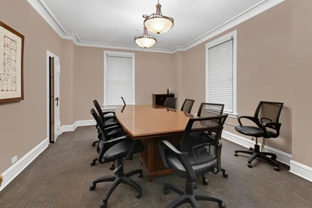 a view of a dining room with a table and chairs