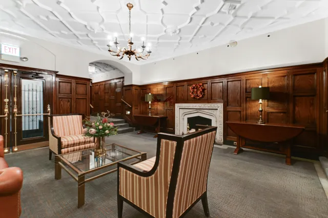 a living room with furniture a fireplace and a chandelier