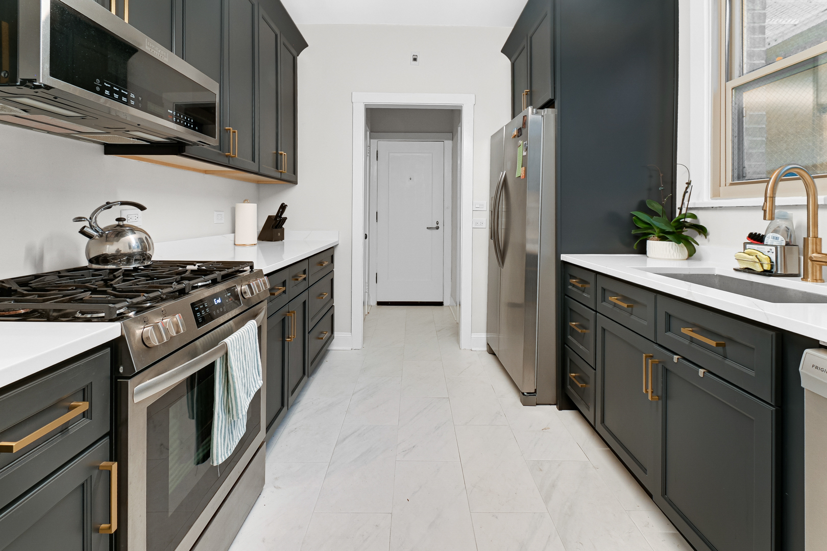 5000 South East End Avenue, Unit 2D Chicago, IL 60615 - Photo 10 of 22 a kitchen with stainless steel appliances granite countertop a stove a sink and a refrigerator