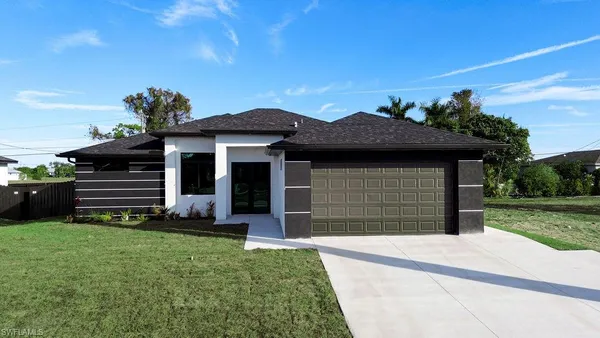 a front view of a house with a garden