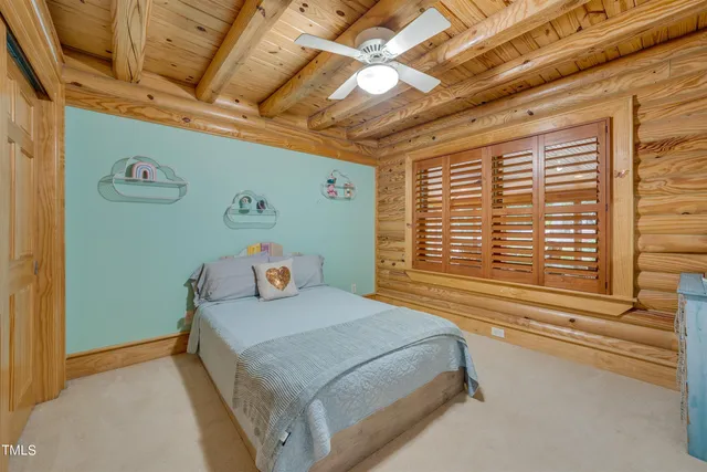 a bedroom with a large bed closet and window