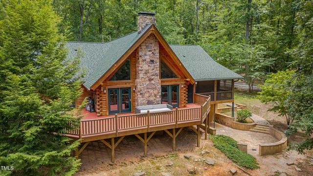 a view of swimming pool with lawn chairs and plants