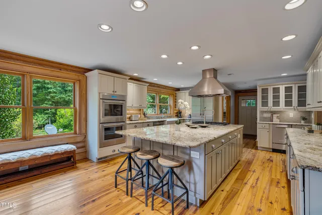 a living room with furniture large window and fireplace