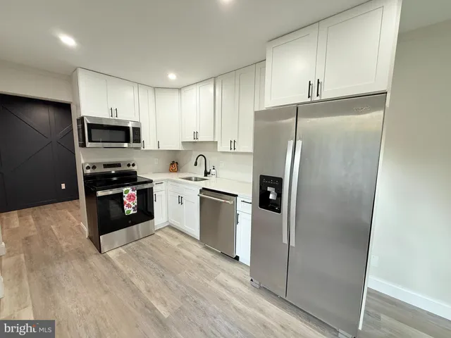 a kitchen with a refrigerator sink and microwave