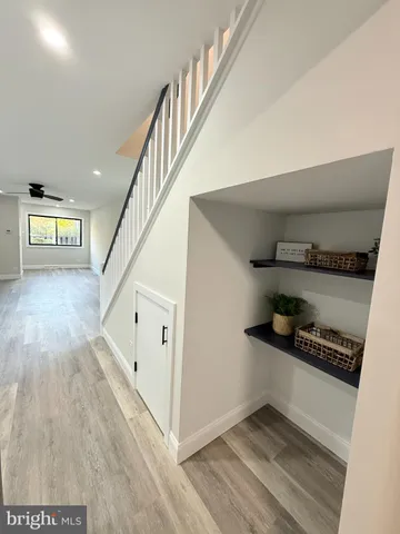 a view of entryway and hall with wooden floor