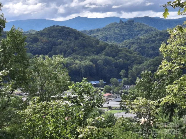 a view of an white house with a yard