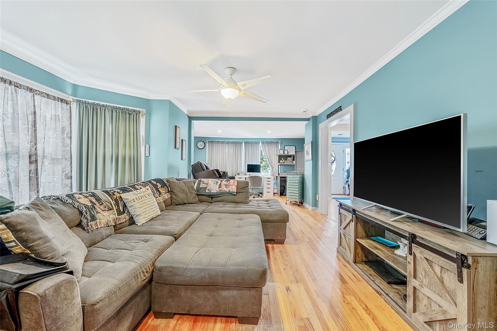 80 George Street Babylon, NY 11702 - Photo 21 of 41 a living room with furniture and a flat screen tv