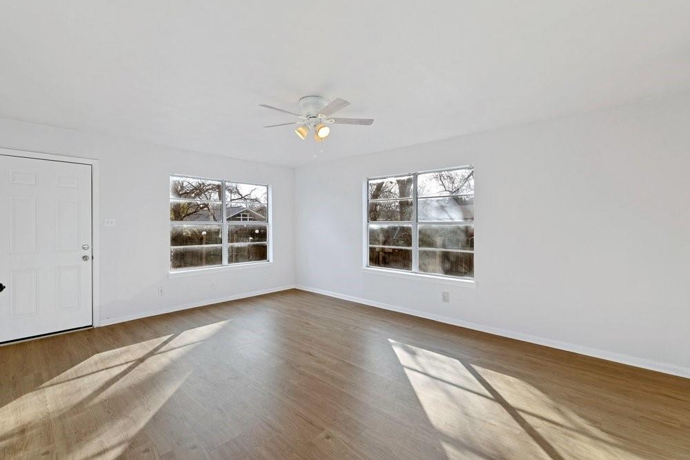314 Fulton Street Denton, TX 76201 - Photo 12 of 29 a view of an empty room with a window and wooden floor