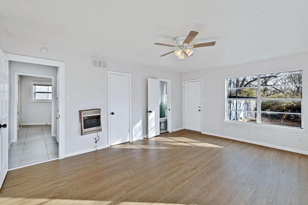 314 Fulton Street Denton, TX 76201 - Photo 13 of 29 a view of a livingroom with wooden floor and kitchen appliances