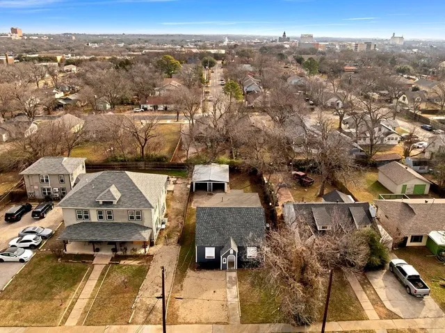 an aerial view of residential houses with city view