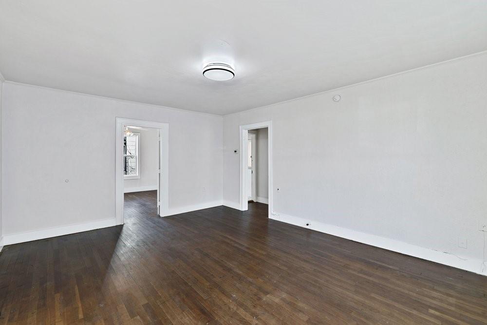 314 Fulton Street Denton, TX 76201 - Photo 5 of 29 a view of an empty room with wooden floor and a window