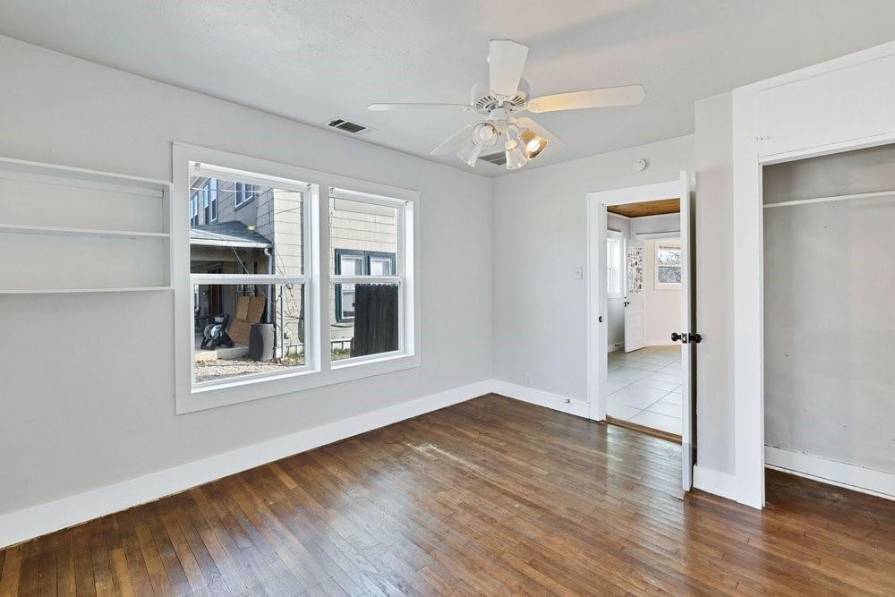 314 Fulton Street Denton, TX 76201 - Photo 6 of 29 a view of an empty room with wooden floor and a window