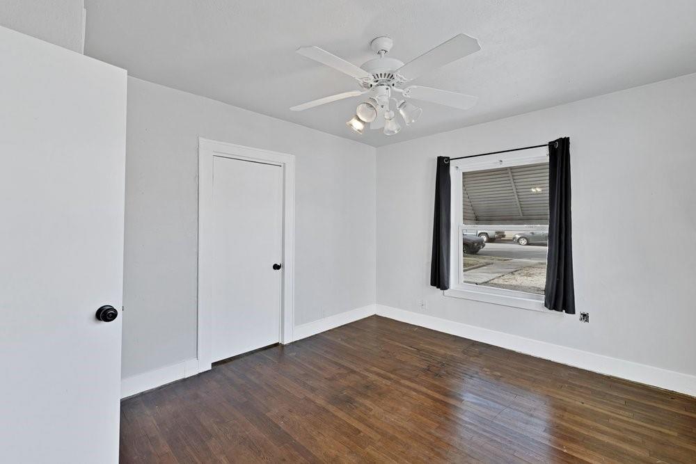 314 Fulton Street Denton, TX 76201 - Photo 7 of 29 a view of an empty room with wooden floor and a mirror
