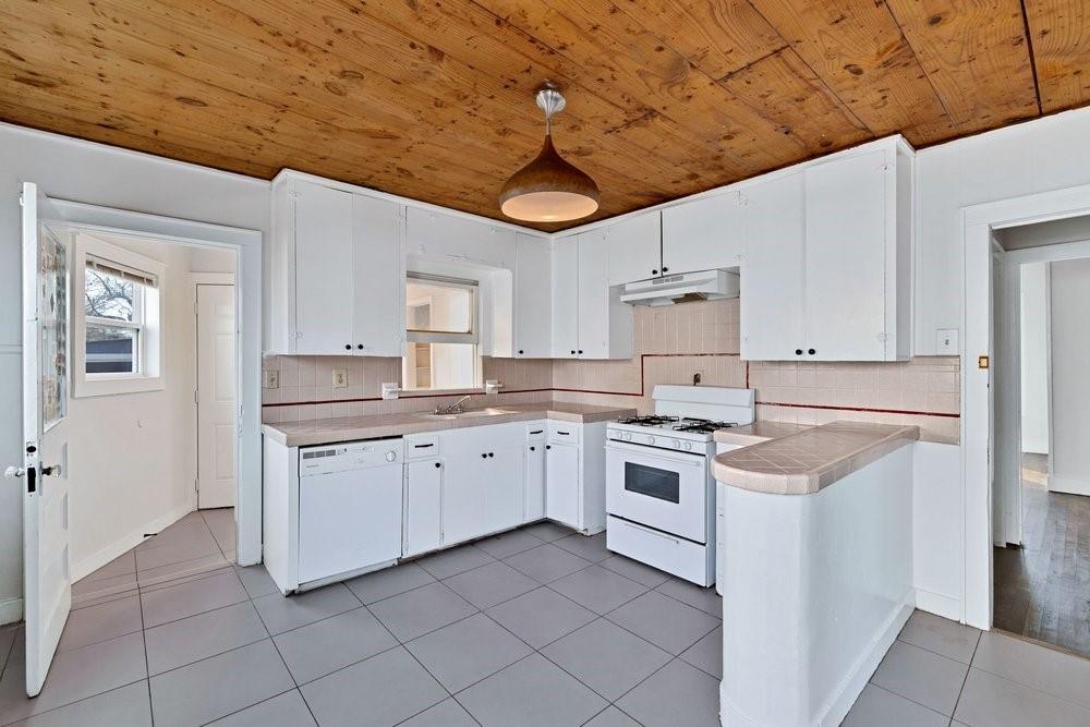 314 Fulton Street Denton, TX 76201 - Photo 8 of 29 a kitchen with granite countertop cabinets stainless steel appliances and a counter space