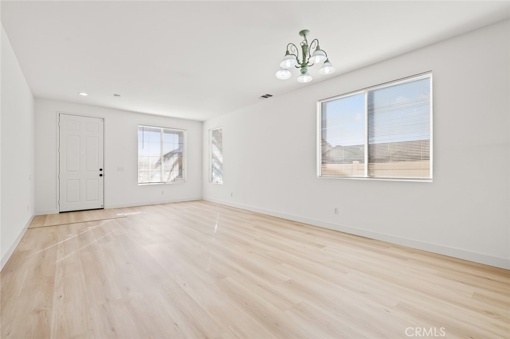 6323 Scalea Court Palmdale, CA 93552 - Photo 11 of 58 a view of empty room with wooden floor and fan
