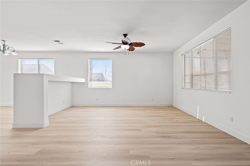 6323 Scalea Court Palmdale, CA 93552 - Photo 12 of 58 wooden floor in an empty room with a window