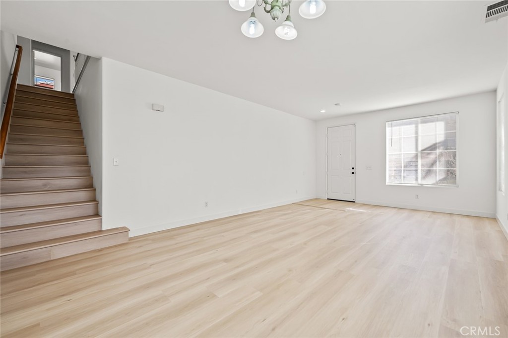 6323 Scalea Court Palmdale, CA 93552 - Photo 13 of 58 an empty room with wooden floor and windows